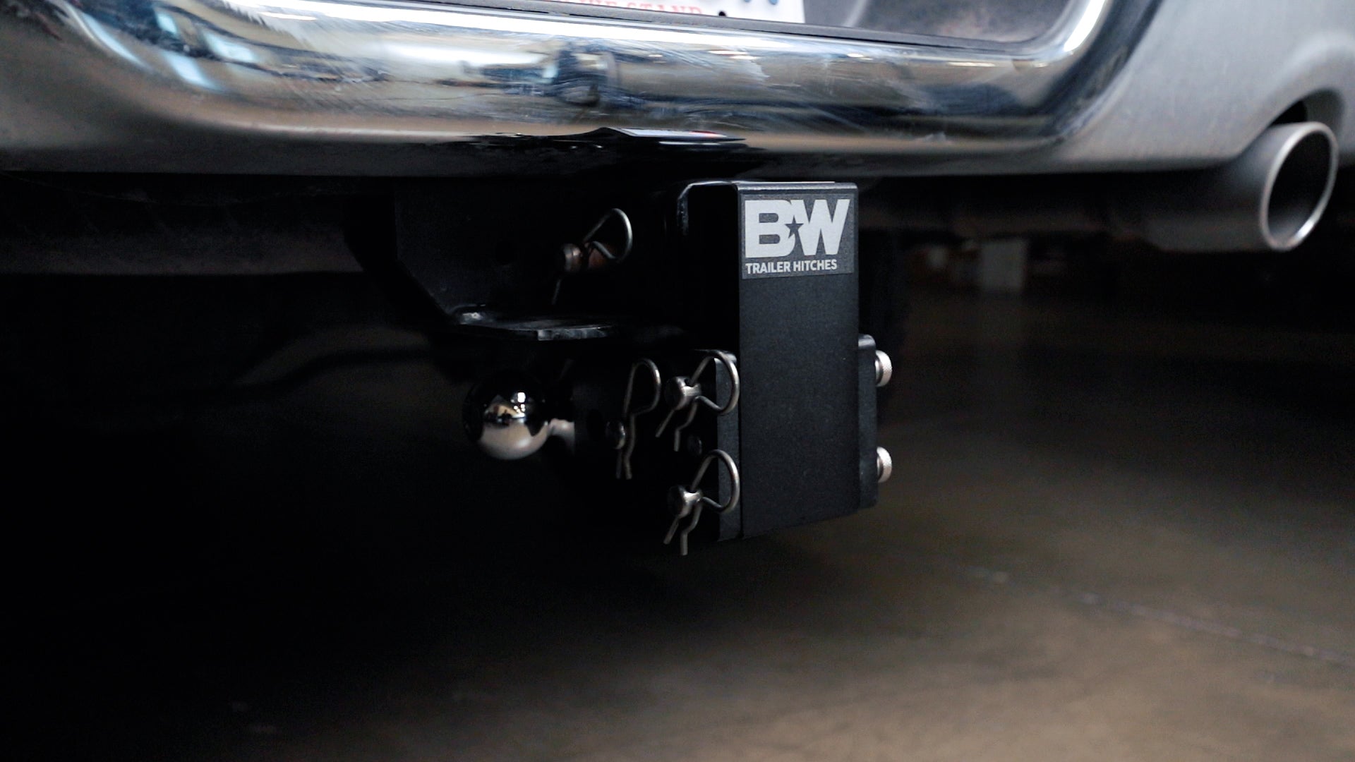 Black B&W TOW & STOW adjustable ball mount hitch attached to vehicle's trailer hitch receiver.
