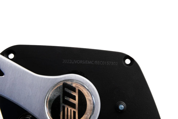 Close-up of the Malibu Control Mefi-6 13-14, showing part of the device with a metallic logo and serial number on a black background.