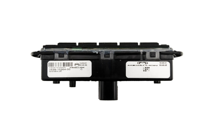 Left Mux Switch Module with black plastic casing, labels, and connector port, used for vehicle electronic control systems.