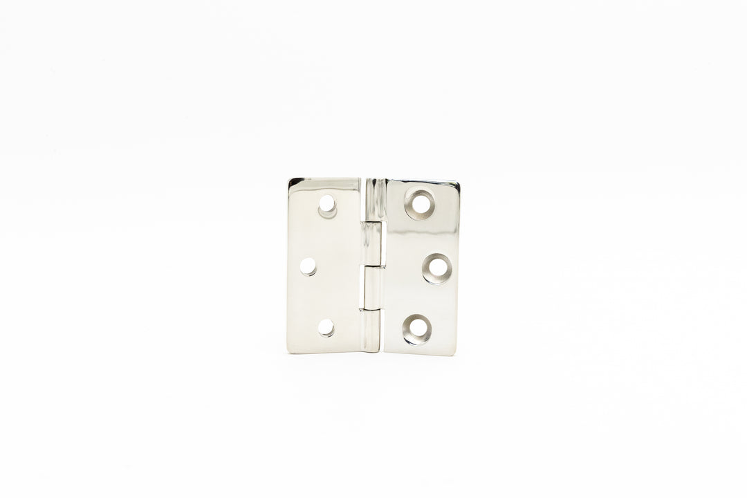 Close-up of a shiny metal Surf Gate Hinge with multiple screw holes, isolated on a white background.