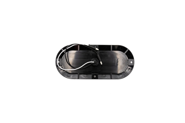 Oval-shaped reverse light with a clear lens, white LED, and black wiring, designed for vehicle lighting.
