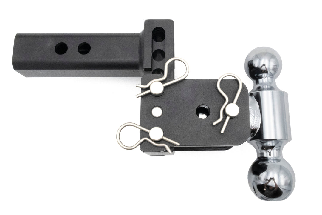 Black B&amp;W TOW &amp; STOW adjustable ball mount with chrome hitch ball and safety clips, used for towing trailers.