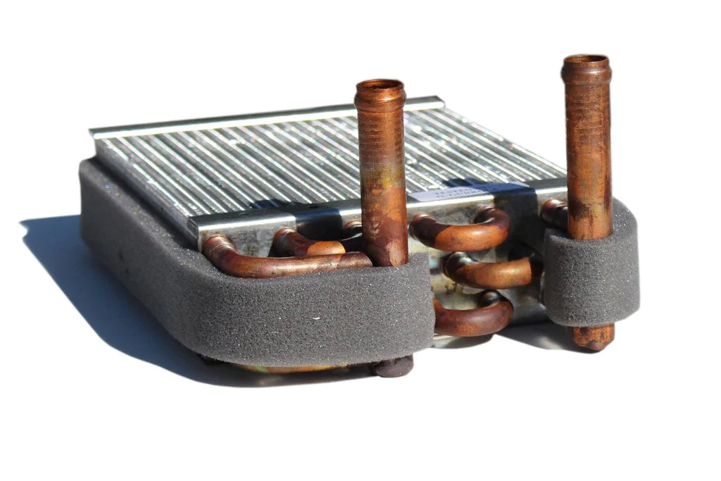 Alt text: Close-up of a 2-vent heater core designed for exclusive use with Heater Craft models, featuring a metal fin grid and rusted copper tubes with insulated ends, against a white background.