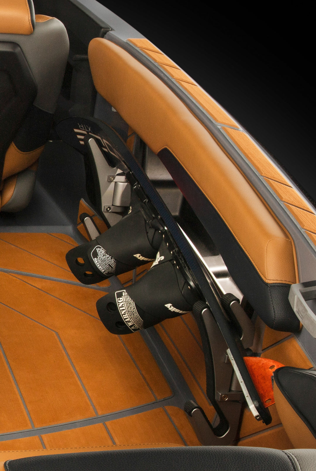 Aluminum Malibu Gunnel Ski Rack mounted inside a boat with tan leather seats and wood-like flooring, designed to hold water skis securely.