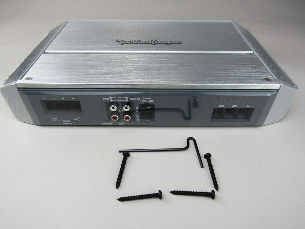 Rear view of a Rockford Fosgate amplifier with input/output ports and mounting screws on a white surface.