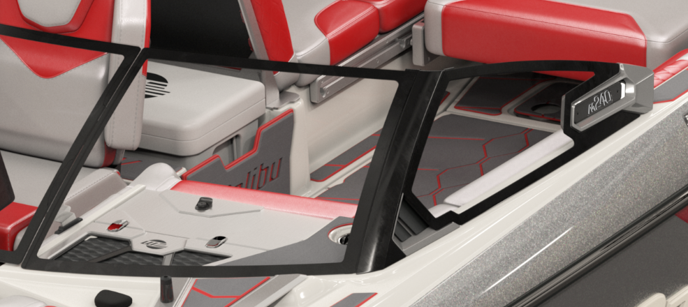 Close-up of the M240 Port Windshield on a boat, featuring a black frame and clear glass, mounted on a red and gray deck.