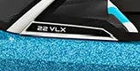Backlit model designator "22 VLX" on port side of a 2016-2018 boat windshield with blue textured surface.